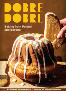 Dobre Dobre cookbook by Laurel Kratochvila shows a hand pulling a slice from an iced Bundt cake