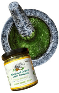 Elephant Green Chili Chutney jar against a mortar and pestle with the chutney inside