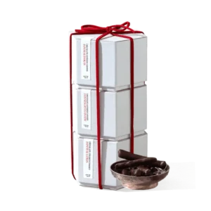 A tier of Dandelion Chocolates includes Japanes candied citrus in each box, tied with a red ribbon